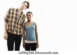 Studio portrait showing contrasting height of young couple