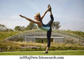 Woman practising yoga in park
