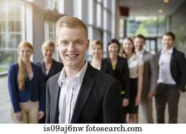Portrait of businessman and business team standing in a row