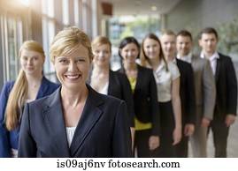 Portrait of businesswoman and business team standing in a row