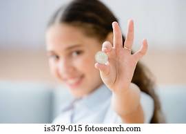 Girl holding a coin