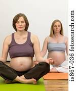 Pregnant women practising yoga