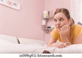 A teenage girl listening to music