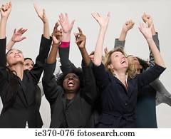 Businesswomen with arms raised