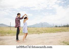 Couple dancing in remote landscape