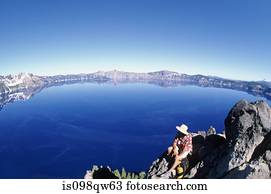 Hiker by crater lake