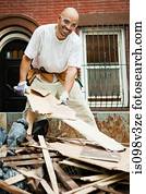 Man filling skip with rubble