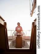 Mid adult man steering yacht