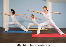 Three women practising yoga