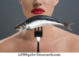 Woman holding a fish on a fork