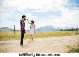 Young couple dancing in remote setting