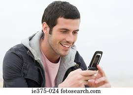 Young man using a cellular telephone