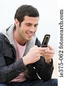 Young man using a cellular telephone