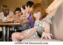 Young woman in a bar with friends