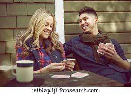 Young couple playing cards