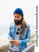 Mid adult man using cell phone