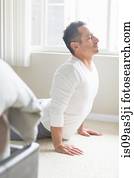 Mid adult man in yoga position