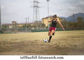 Soccer player practising in field