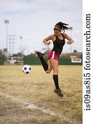 Soccer player practising in field