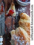 Croissant with jam, overhead view