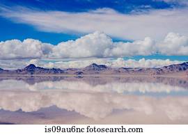 Reflection pool of horizon over water, mountain range and clouds, Bonneville, Utah, USA