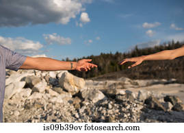 Couple reaching hands out to each other, Ottawa, Ontario