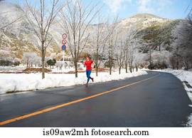 Male runner running on road in winter, Lake Kawaguchiko, Mount Fuji, Japan