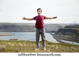 Man standing on mountain top, breathing fresh air, Colombia River Gorge, Washington, USA