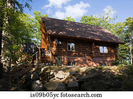 Residential log home in summertime, Quebec, Canada