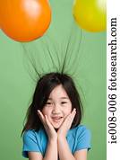 Girl with hair sticking to balloons