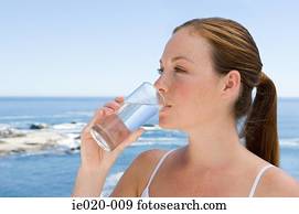 Young woman drinking water