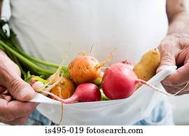 Man carrying vegetables in a t shirt
