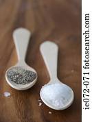 Wooden spoons sea salt and black pepper