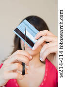 Woman cutting credit card