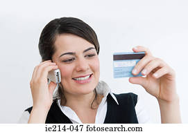 Woman on cellphone with credit card