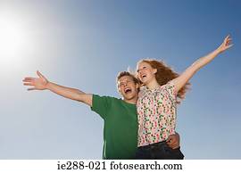 A couple with their arms raised