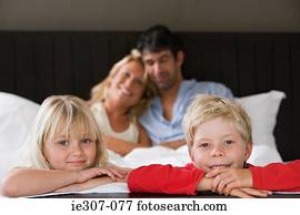 Portrait of a family in bed