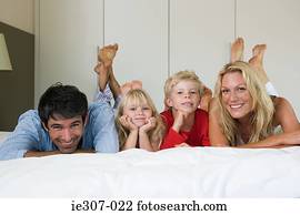 Portrait of a family in bed