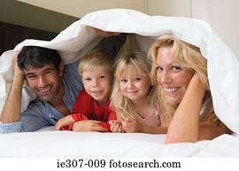 Portrait of a family in bed