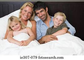 Portrait of a family in bed