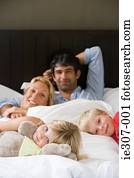 Portrait of a family in bed