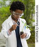 A boy doing an experiment on a plant