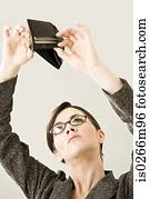 A young woman looking in an empty wallet