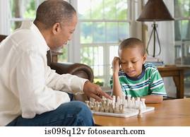 A grandfather and grandson playing chess