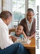 A grandfather and grandson playing chess