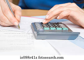 Person with calculator and forms