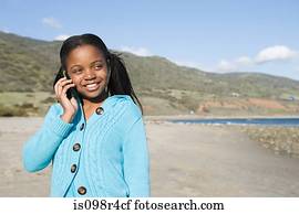 Girl using a cellular telephone