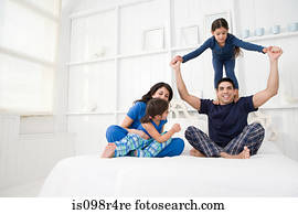 Hispanic family in a bedroom