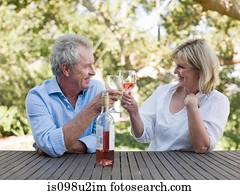Couple toasting with wine outdoors