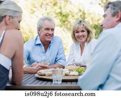 Friends at meal outdoors